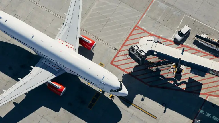 Aviation Training course website. Image of an Airbus A320 from a drone in an airport parked.